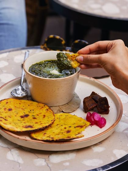Sarson da Saag with Makki di Roti, a seasonal winter classic. We prepare this traditional Punjabi dish with the freshest ingredients, offering an authentic taste of home-style cooking.