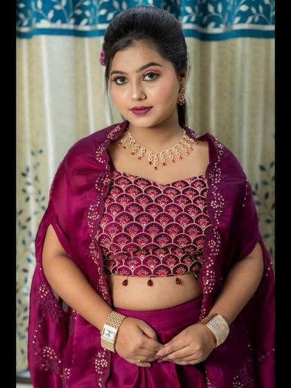 Another close-up of the blouse, which features a beautiful scalloped pattern in sequins, paired with a delicate necklace.