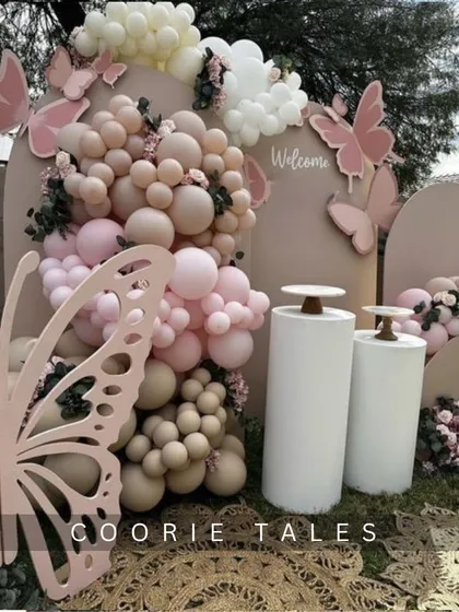 Your celebration can be as delicate and beautiful as a butterfly's wing. This outdoor setup features intricate, large-scale butterfly cutouts, a soft pink and neutral balloon arrangement, and floral accents for a truly enchanting experience.
