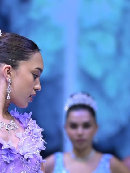 A close-up of the intricate details and accessories from the GULFAM runway show, featuring a beautiful tiara and delicate floral appliqués.