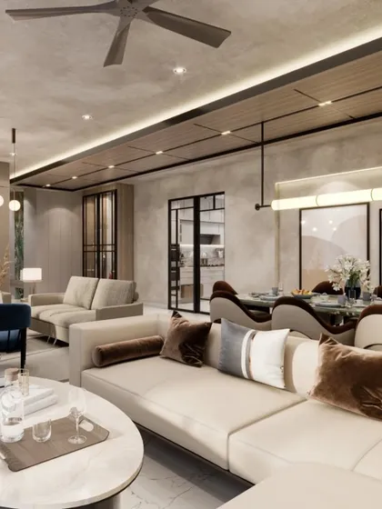 A closer look at the living area, where a sleek wooden ceiling panel adds warmth and texture. The space is designed with dual seating arrangements to accommodate both formal and informal gatherings.