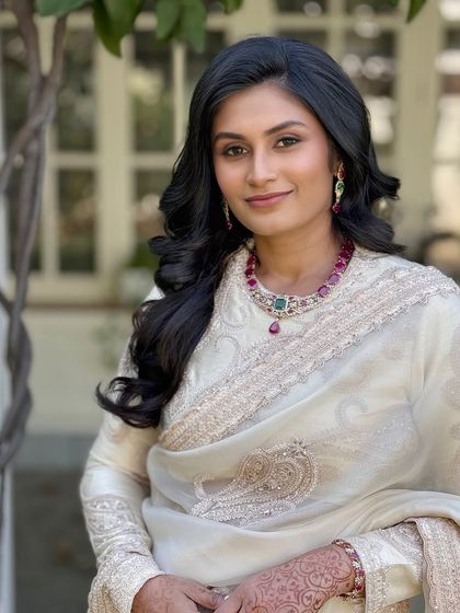 A close-up profile, highlighting the flawless skin and the beautiful contrast of the jewellery.