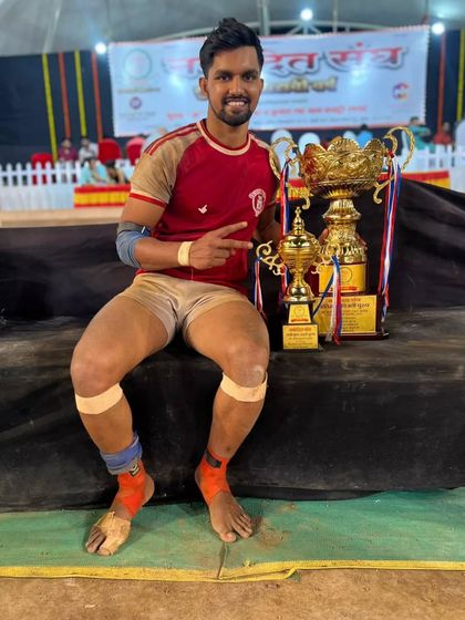 Raj Natekar, recognized as the 'Best Raider of the Tournament', posing with his trophies.