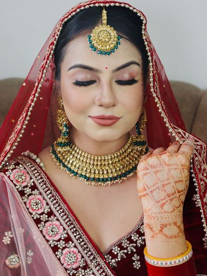 A close-up of the bride's face, focusing on the flawless HD makeup.