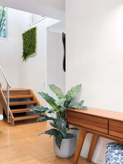 You can add a splash of color indoors too. In this home, I installed two different artificial plant panels, one with lush green and another with deep purple, to complement the modern interior design.