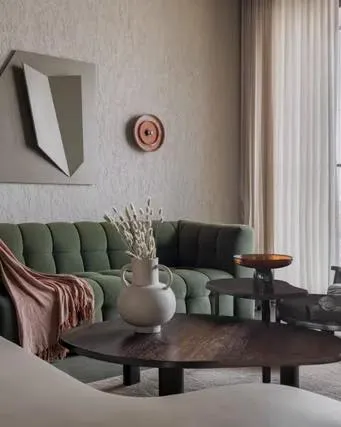 We focus on the details that create a soulful experience. This close-up from a Mumbai apartment by officearsa highlights the beauty of material authenticity, where textured walls, an olive green sofa, and curated objects come together to form a quiet, expressive corner.