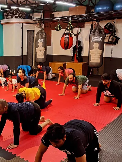 The squad is focused during a floor-based mobility drill. Everyone, regardless of their level, puts in the work.