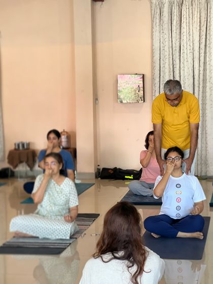 I guide students during a pranayama class, ensuring they maintain a correct and comfortable posture.