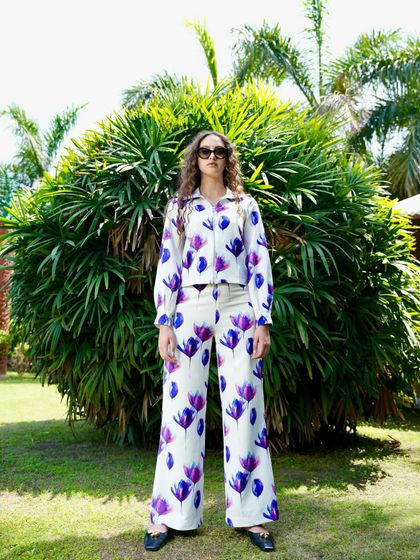 For this summer collection, I styled a white co-ord set with a bold purple floral print. The wide-leg pants and matching shirt create a relaxed yet polished look.