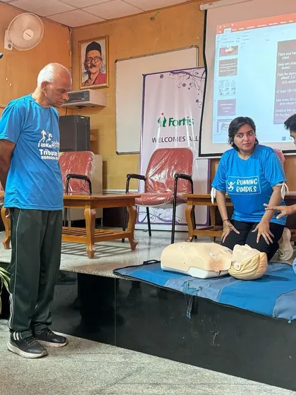 Hands-on learning during our Basic Life Support workshop. An instructor guides our volunteers on the correct CPR techniques using a mannequin.