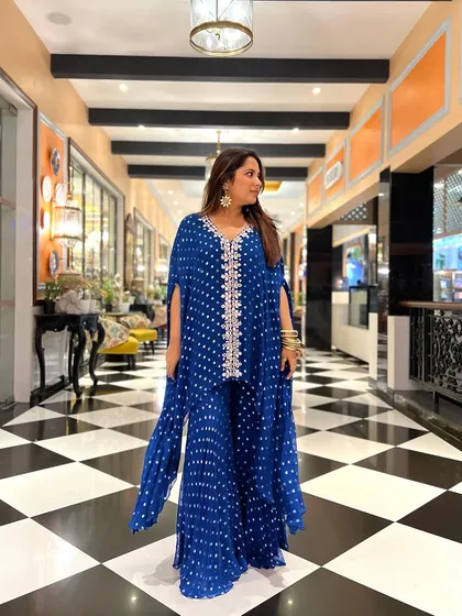 Here’s a look from my own wardrobe. I chose this royal blue bandhani-print sharara set with a cape for a wedding. It was comfortable, chic, and perfect for dancing the night away at the baarat.