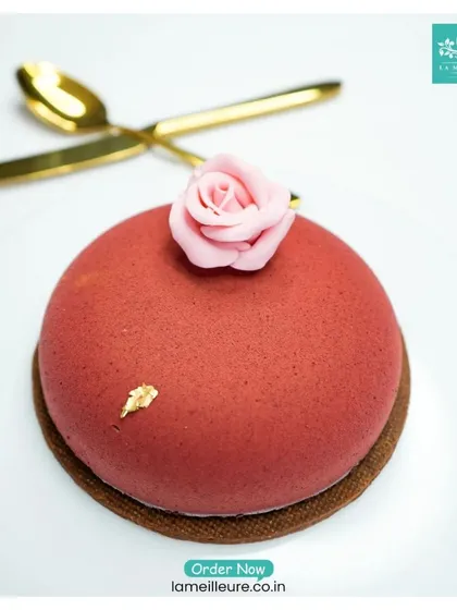 At the heart of our hampers are our patisserie creations. This elegant rose-topped dessert showcases the artistry and premium ingredients we use, from rich chocolate mousse to delicate gold leaf accents.
