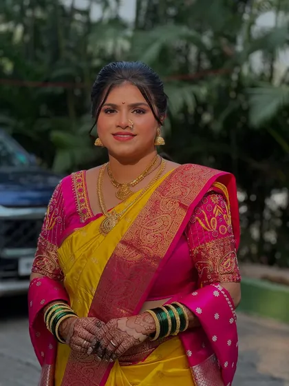 A classic portrait of a Maharashtrian bride, with soft makeup that lets her natural beauty and traditional attire shine.