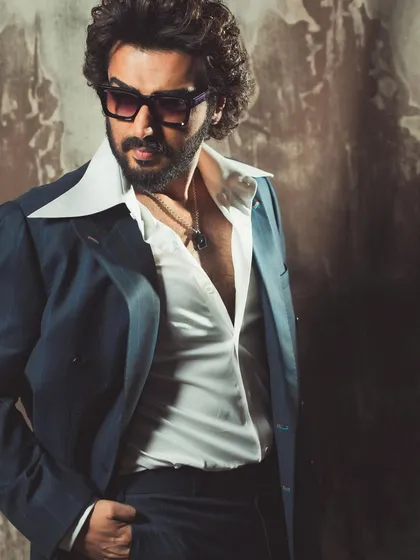 This shot captures the confident and relaxed vibe of the retro-inspired suit. It's designed to be worn with an attitude that is both elegant and effortless.