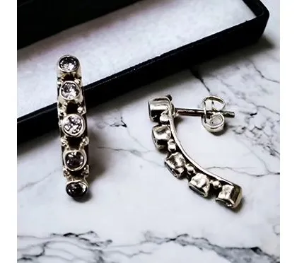 These unique curved ear-climber earrings are studded with zirconia, designed to follow the natural curve of your earlobe for a modern look.