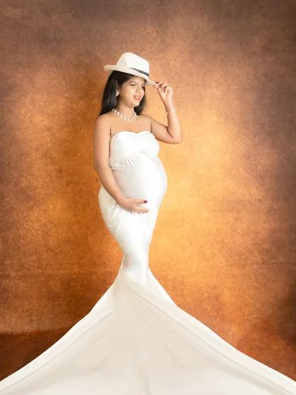 Adding a simple prop like a hat can bring a touch of personality and style to a classic fine-art drape portrait.