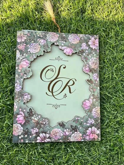 The beauty is in the details. This design features an intricate floral laser-cut frame on a soft sage green, revealing a custom monogram that tells your unique love story. It’s a piece of art that your guests will treasure.