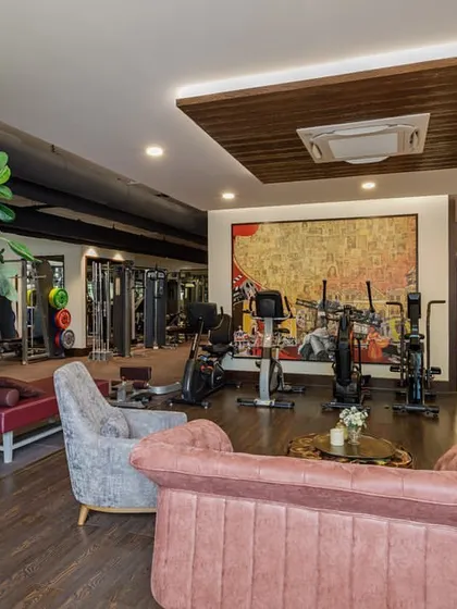 A home gym doesn't have to feel cold and industrial. For this private gym, I incorporated a comfortable lounge area with soft furnishings and art, creating a space that motivates you to work out and invites you to relax afterward.