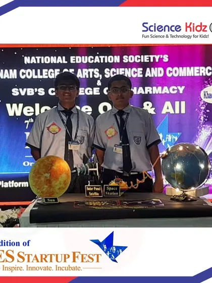 The team standing at their presentation booth at the NES Startup Fest. These events teach students how to set up a professional display and engage with judges and the public.