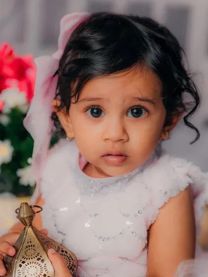 Those big, curious eyes are so precious. This close-up from her first birthday shoot captures her sweet and inquisitive nature.