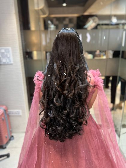A stunning open hairstyle with long, flowing curls and pearl accents, perfect for a princess gown.