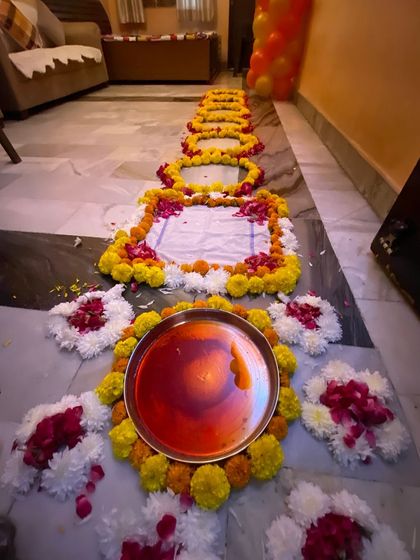 Here is a detail of the traditional welcome pathway I create for a 'griha pravesh' ceremony. I use fresh marigold and other flowers to design the path, including a decorated thali for the welcome ritual, to honor cultural traditions for the newlyweds.