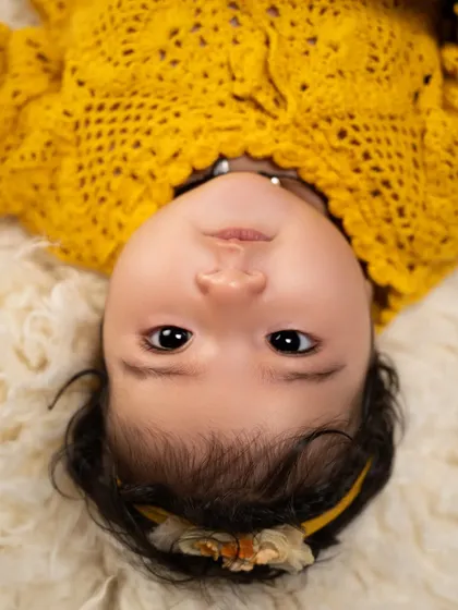An expressive close-up from an upside-down perspective. We love finding unique angles to capture your baby's beautiful features and curious eyes.