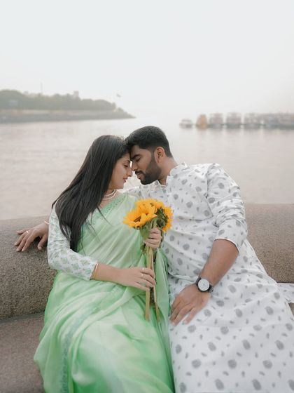 An intimate moment sitting on the sea wall, with the sunflowers adding a pop of color.