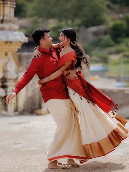 A full-body shot of the couple dancing, capturing the movement of the bride's traditional skirt.