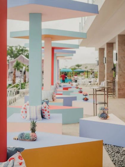 A different angle of the geometric brunch setup, showing the interplay of shapes and colors. The custom cushions with lip and stripe patterns added another layer of playful detail.