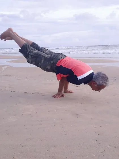 Here I am practicing Mayurasana, or Peacock Pose, on a quiet beach. This advanced arm balance builds strength and improves digestion. The sound of the waves and the sand beneath my hands makes the practice even more grounding.