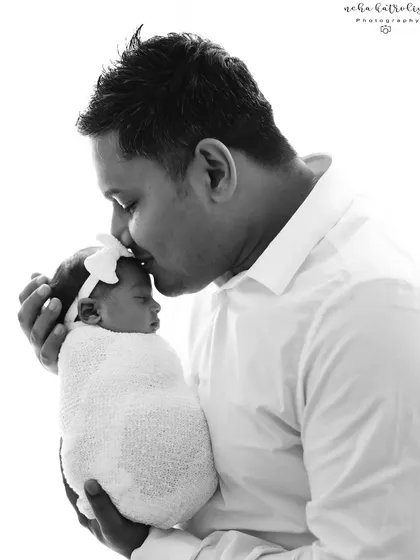 A father's gentle love. This black and white portrait focuses on the powerful, quiet connection between a dad and his brand new baby girl.