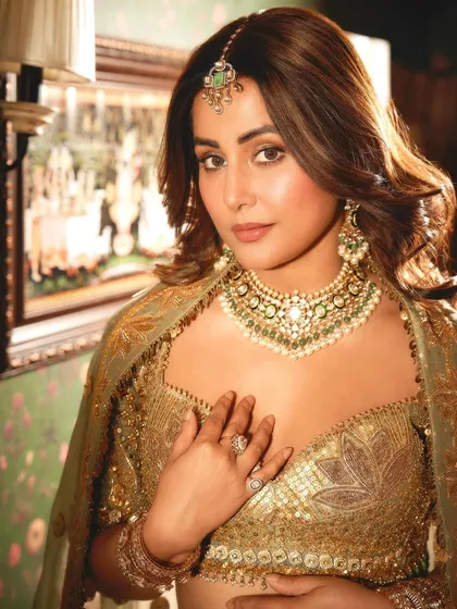 A portrait of royalty. Hina Khan exudes confidence and grace, her look elevated by the intricate craftsmanship of her polki and emerald bridal jewelry set.