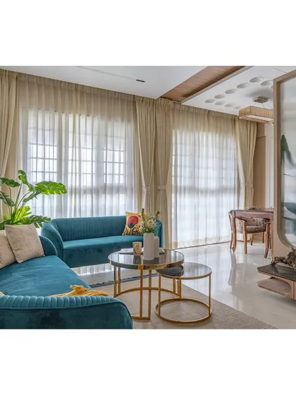 The combination of the modern teal sofa and the traditional dining set in the background showcases our ability to mix styles effectively, creating a home that is unique to our clients.