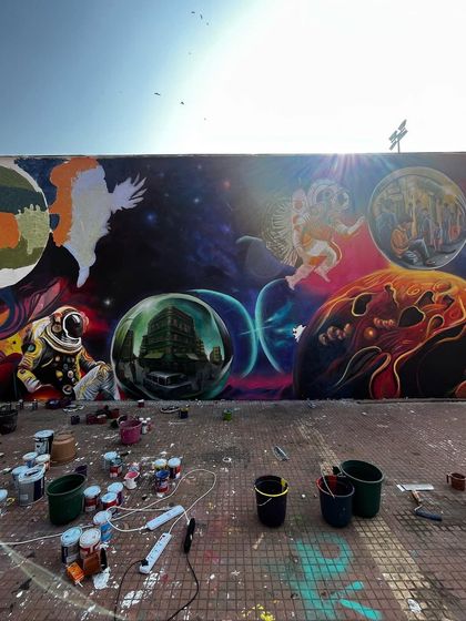 The mural at IIT Bombay in progress. This shot captures the organised chaos of a large-scale project, with paint buckets and ideas scattered, all coming together on the wall.