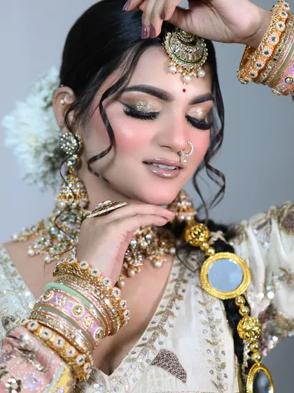 A detailed shot of the glittery eye makeup and the stunning bridal jewelry.
