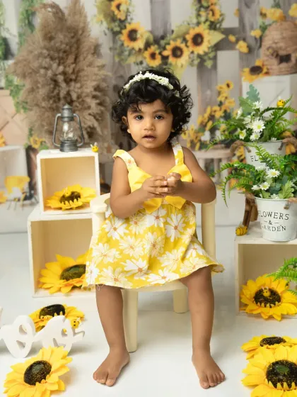 A sweet portrait amidst a field of sunflowers. This setup is perfect for capturing the cheerful spirit of a toddler.