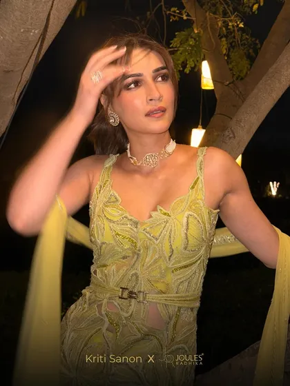 A star shining bright. Kriti Sanon pairs a delicate diamond choker and earrings with her lime green attire, showcasing a perfect fusion of modern style and festive glamour.