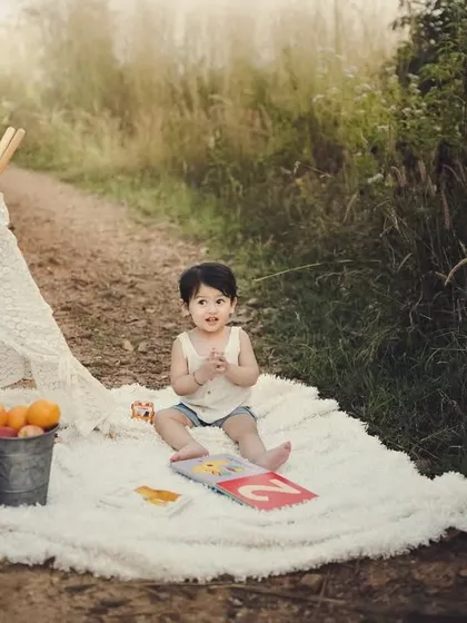 I have a special love for outdoor shoots. There's something magical about the natural light, the open space, and the pure joy of a child exploring nature, like in this cozy teepee setup.
