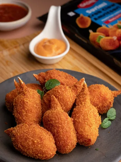 A clean, crisp product shot of Gadre's Crab Lollipops. The focus here is on the golden, crunchy texture, making it an ideal image for packaging or online menus.