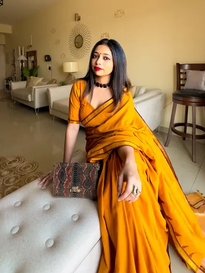 A relaxed, at-home shot before heading out. The yellow saree just brightens up the entire space.