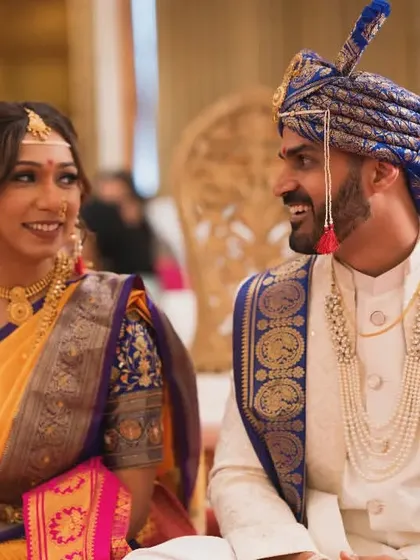 The bride and groom sharing a happy, relaxed moment during their wedding ceremony. Our candid wedding photography aims to document the genuine smiles and conversations.