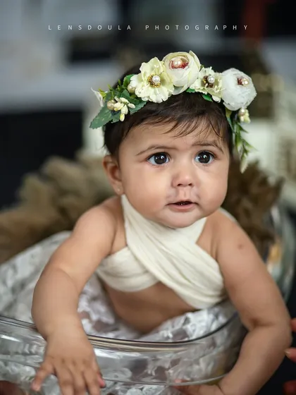 A moment of quiet contemplation. Even in a glamorous setup, we capture the soft, innocent expressions of your baby.