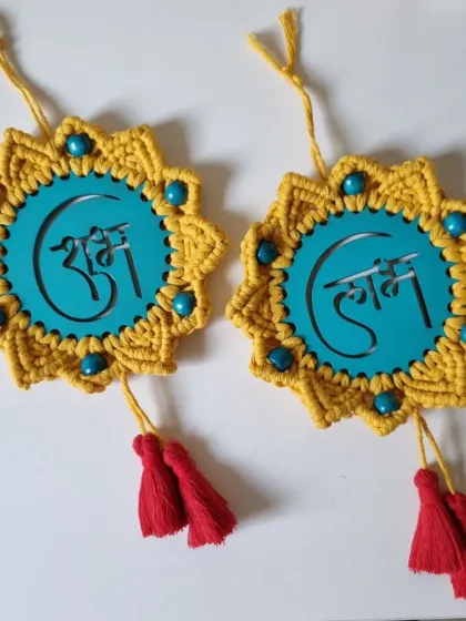 A pair of 'Shubh' and 'Labh' hangings, ready to bring blessings to a new home. The red tassels add a final, auspicious touch.