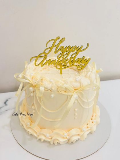 Slaying the vintage look. An elegant anniversary cake with classic buttercream piping and ribbon details.