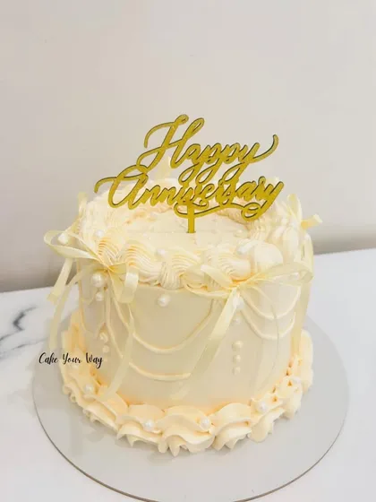 Slaying the vintage look. An elegant anniversary cake with classic buttercream piping and ribbon details.