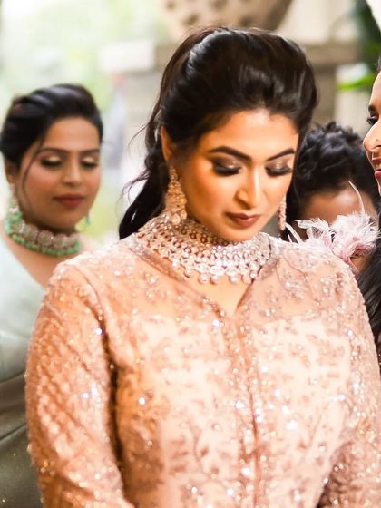 A candid moment from the engagement party. The bride's makeup looks beautiful and natural, even in the midst of the celebration.
