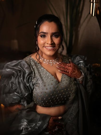 A happy and confident bride at her sangeet. The makeup is bold and beautiful, designed to shine on the dance floor.