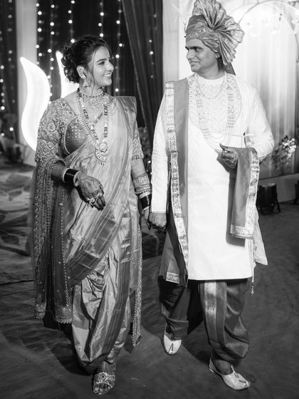 A classic black and white photo of the couple walking hand-in-hand, creating a timeless and cinematic feel.