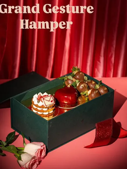 A Valentine's Day gift hamper, combining multiple dessert items. This is a commercial shot designed to sell a complete product package.